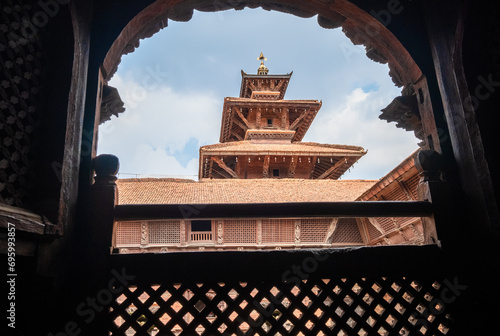 Real architecture masterpiece old temple view through the carved wood window, Patan Durbar Square royal medieval palace and UNESCO World Heritage Site. Lalitpur, Nepal. photo