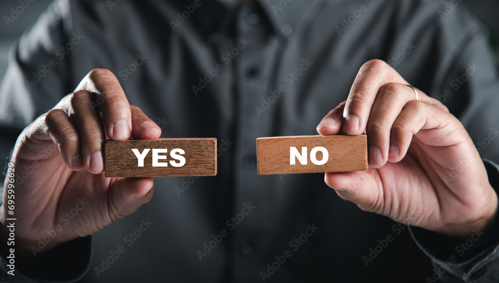 Hands of businessman holding wooden blocks with yes and no words portraying decision-making. Choice symbolizes business success. Think With Yes Or No Choice. - obrazy, fototapety, plakaty 