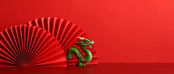 Lunar New Year 2024 background. Chinese dragon with red paper fans on red background.