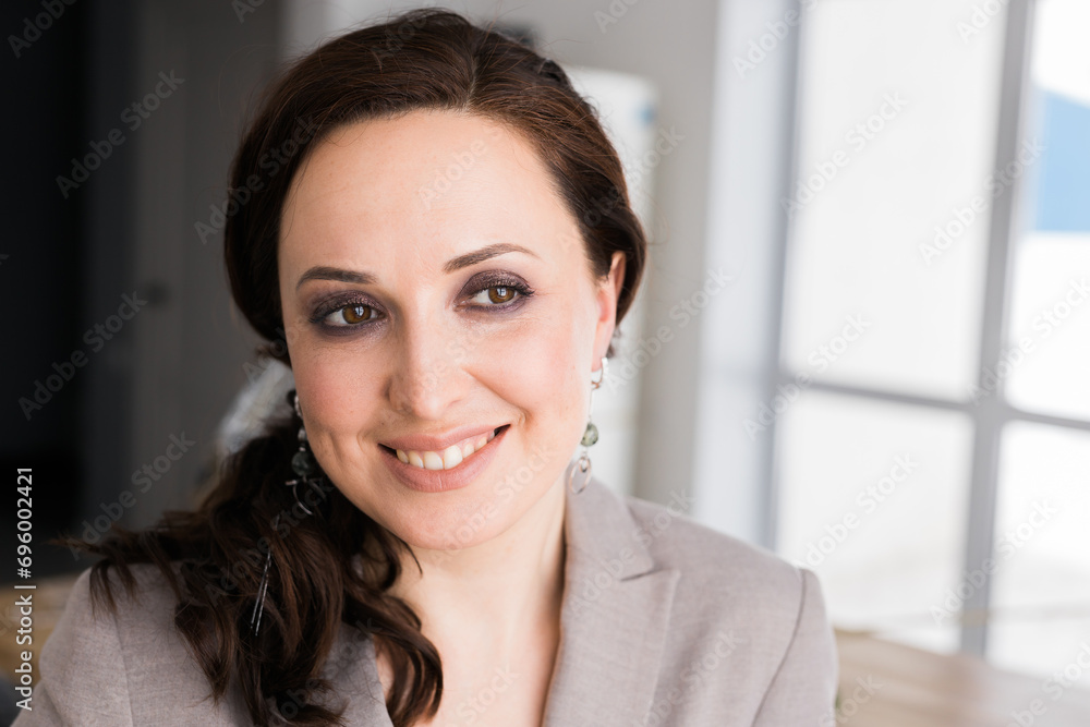 Portrait of a female online store business owner looking away and smiling. Woman doing her small business from home. Copy space and empty place for text Portrait of a female online store business owner looking away and smiling. Woman doing her small business from home. Copy space and empty place for text
