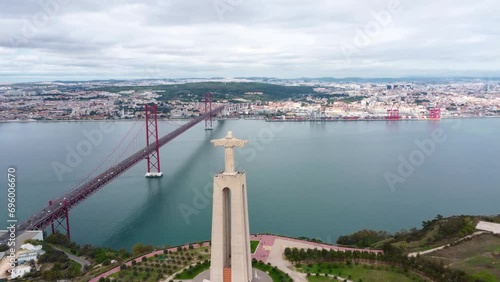 Aerial perspective of Santuario de Cristo Rei Statue and 25 Abril Bridge. The Statue is situated in Almeda and the bridge connect the Lisbon city with Almada.  photo