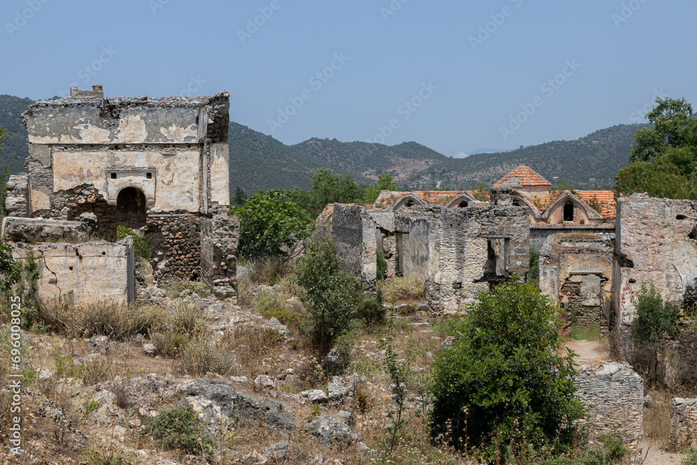 Abandoned Village of Kayakoy: many deserted stone houses, dead city looks like ancient ruins. Yukari Kilise is an old Greek damaged church.