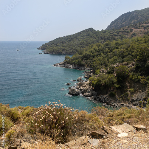 A wide blue lagoon on the Mediterranean coast of Turkey. Top view from high cliff of Burgas Beach which close to Abandoned Village of Kayakoy. © Vadim