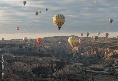 rising sun lit the numerous hot-air balloons in the early morning, Cappadocia, Turkey