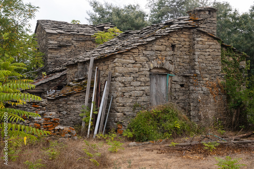 Abandoned old traditional Ikarian stome house with slate roof in the mountain village of Christos Raches. photo