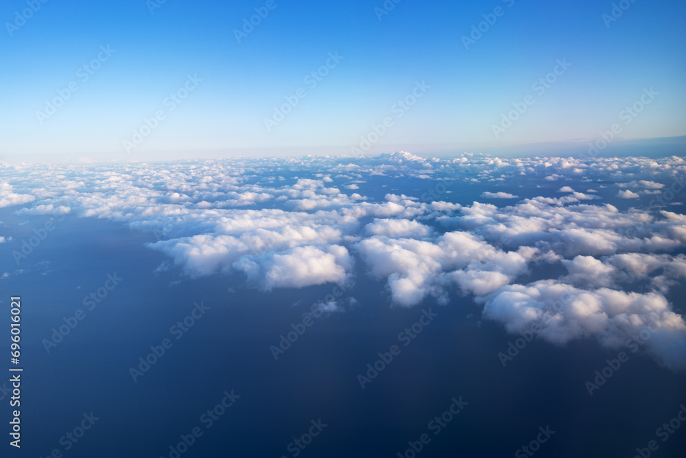 Rare white fluffy clouds, top view, in the evening sky