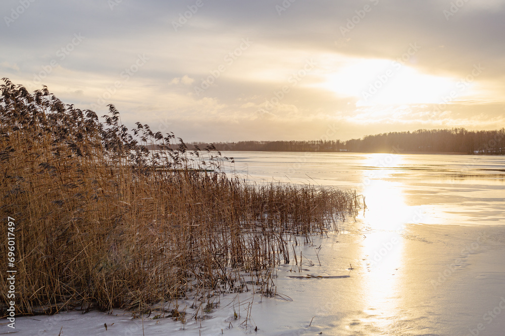 Sunset moment at the frozen lake Lielezers in December in Limbazi in Latvia