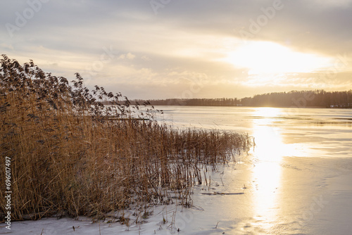 Sunset moment at the frozen lake Lielezers in December in Limbazi in Latvia