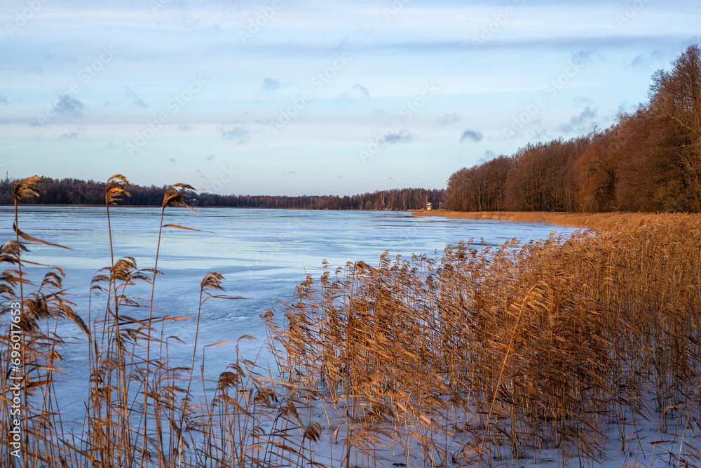 Sunset moment at the frozen lake Lielezers in December in Limbazi in Latvia