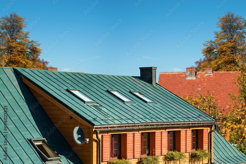 houses with different roofs, metal and tiles