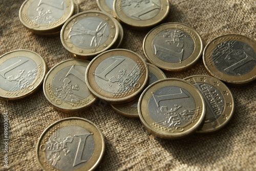 One euro coins on natural linen fabric. Business and finance.