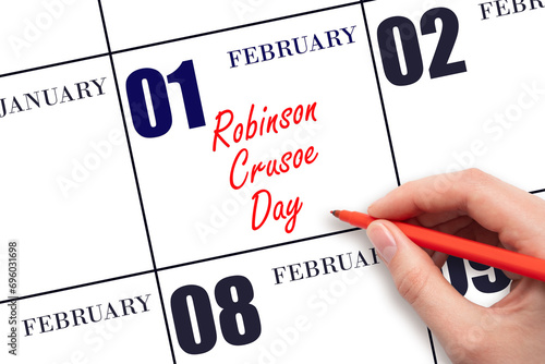 February 1. Hand writing text Robinson Crusoe Day on calendar date. Save the date.