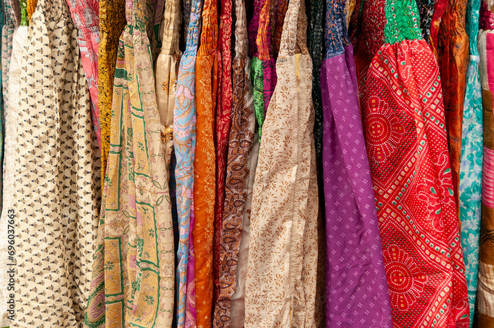 Multi-colored, patterned, cotton material hanging on a clothing rack Multi-colored, patterned, cotton material hanging on a clothing rack