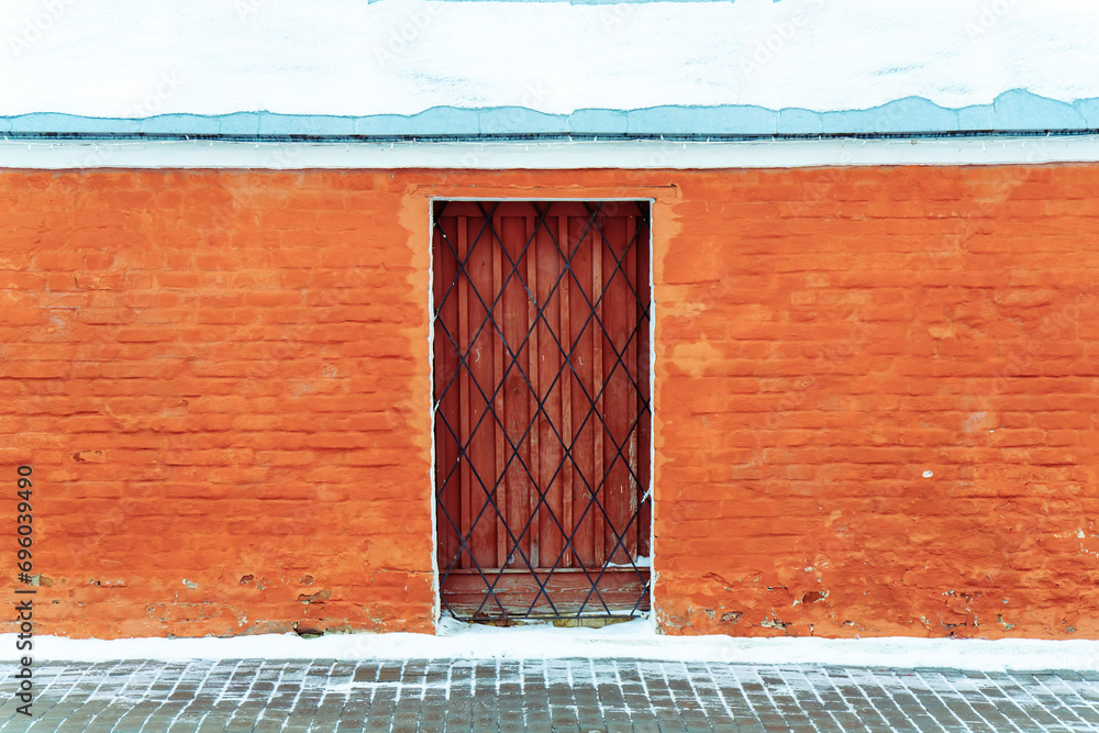 Door and metal grille in red brick wall Door and metal grille in red brick wall