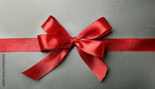 a red satin ribbon tied in a bow