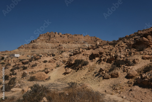 Chenini deserted hilltop old berbere town in Tunisia against blue sky, Africa photo