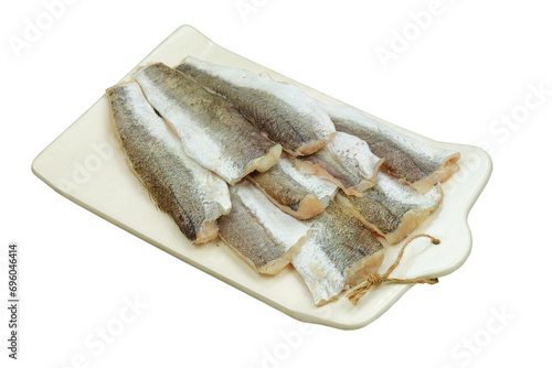 Raw hake on a ceramic board isolated on white background. Hake Filet. Ready to cooking. Raw fish. photo