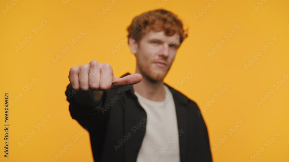 Confident Red Haired Man Pointing Thumb Down Confident Red Haired Man Pointing Thumb Down