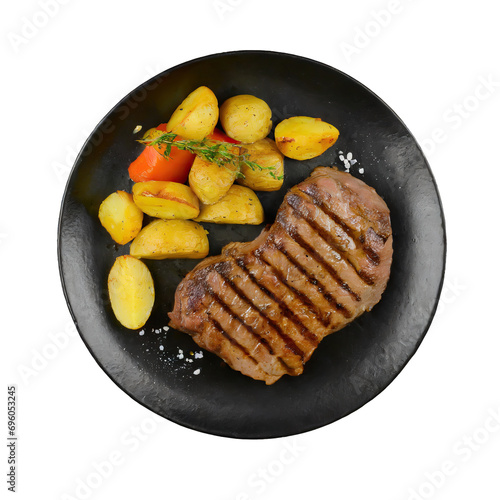 black plate with grilled beef steak and potatoes top view