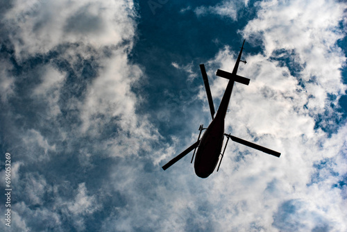 helicopter silhouette in dark clouds © Robert