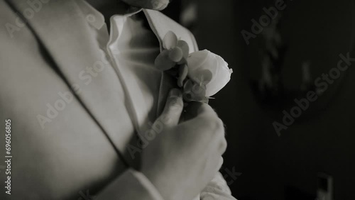morning of the groom in a beautiful jacket and boutonniere before the wedding ceremony and meeting the bride photo