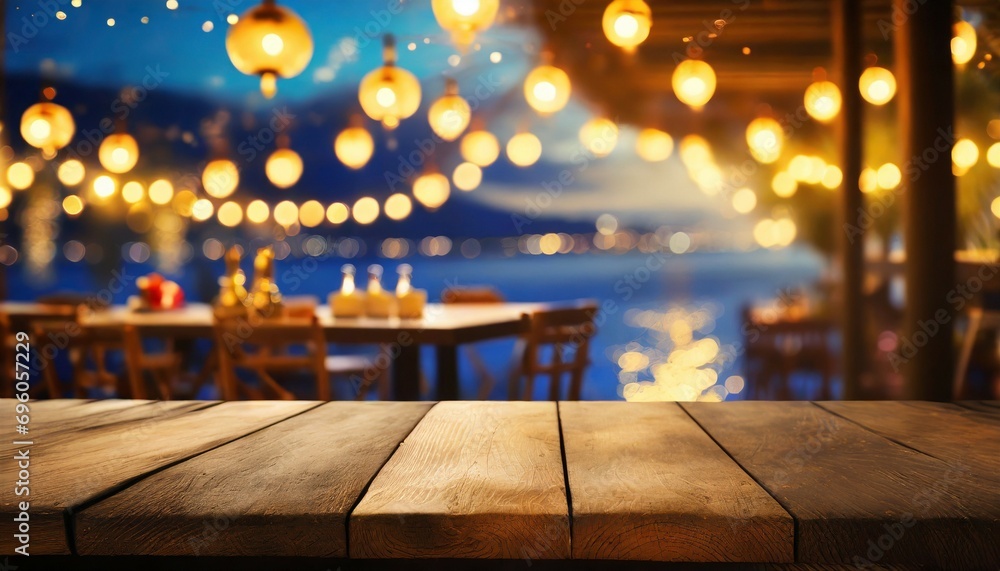 image of wooden table in front of abstract blurred restaurant lights background