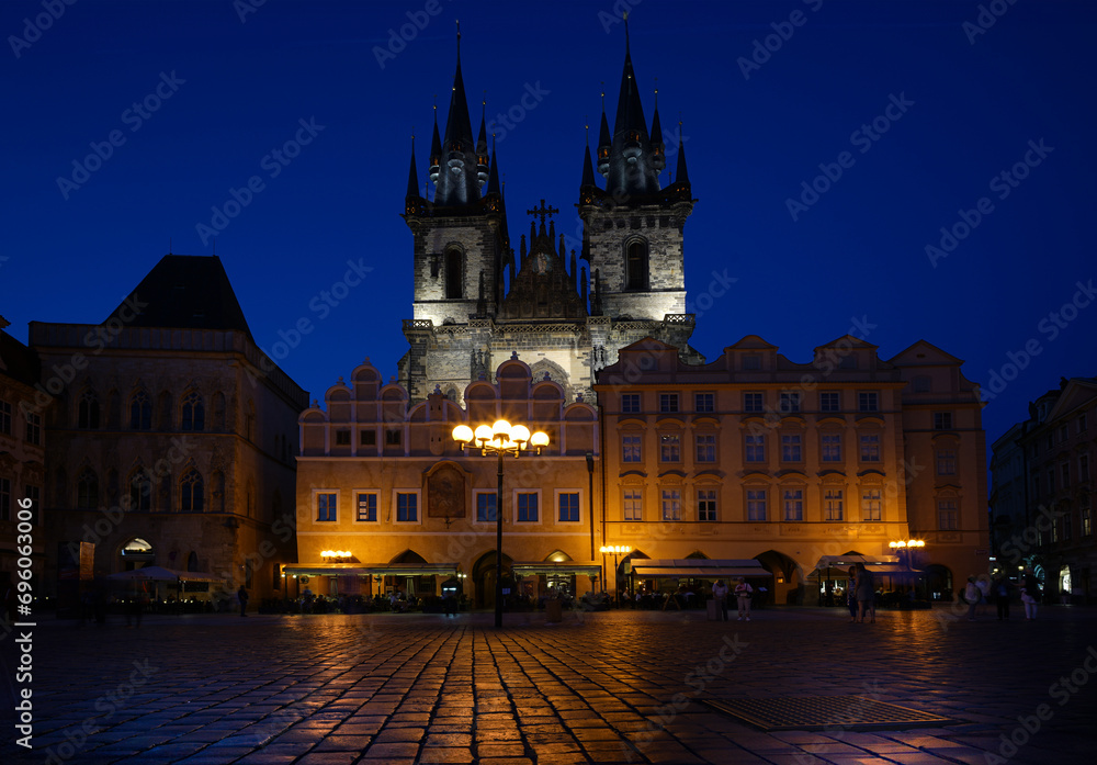 Historic city square at night with illuminated buildings and lights