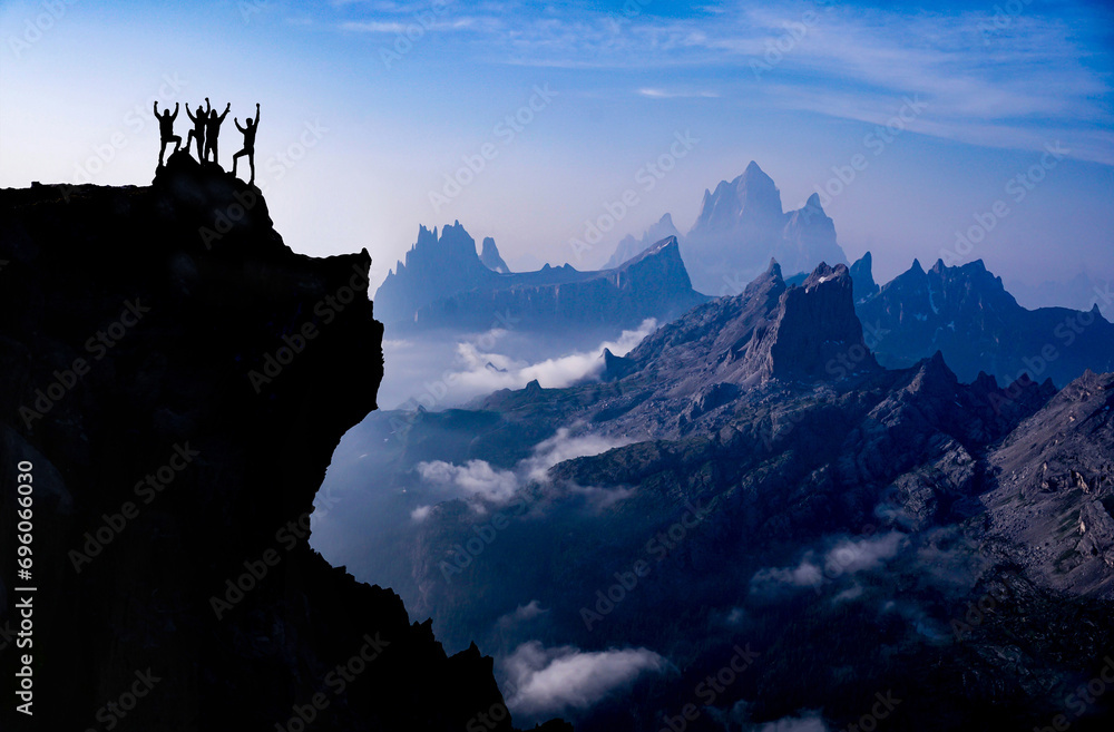 The triumph of four professional climbers at the top of mystical and extraordinary mountains - obrazy, fototapety, plakaty 