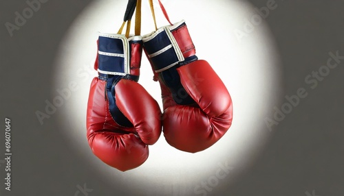 pair of boxing gloves hanging on white background