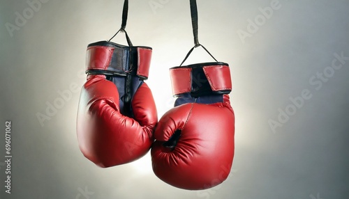 pair of boxing gloves hanging on white background © Leila
