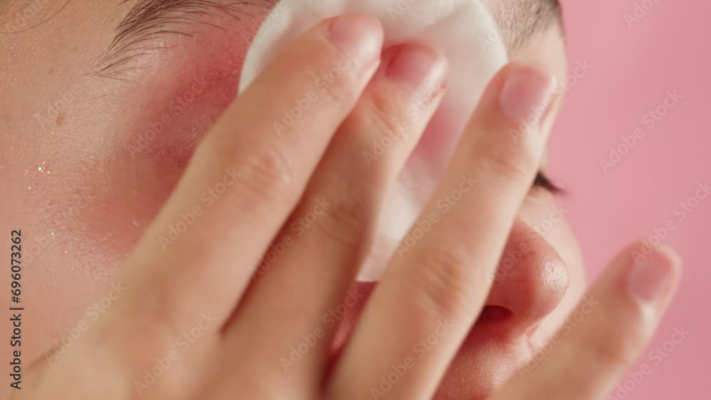 Young woman cleaning washing her face with cotton pad after make-up products. Skin care, beauty cosmetic treatment, morning routine 