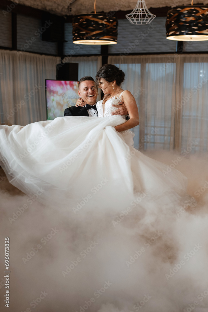 the first dance of the bride and groom inside a restaurant