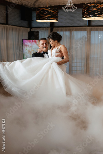 the first dance of the bride and groom inside a restaurant