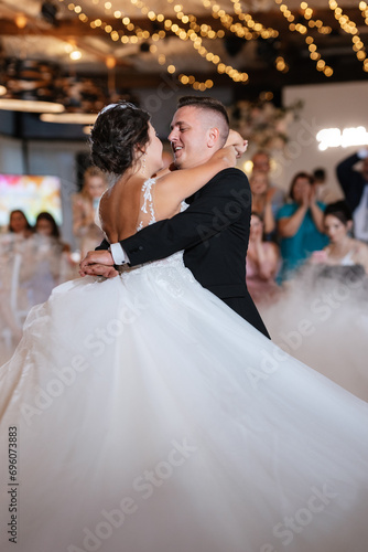 the first dance of the bride and groom inside a restaurant