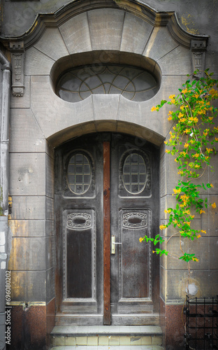 Old weathered, grunge, spooky and damaged wooden house entrance door