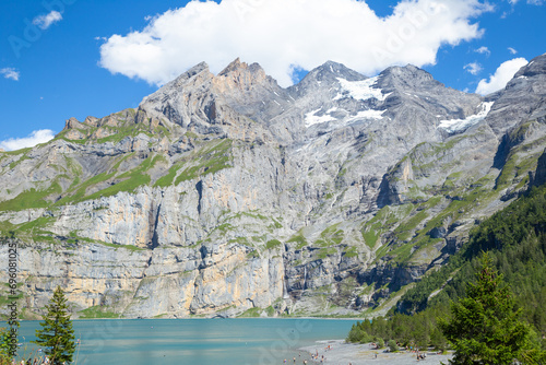 Oeschinen Lake with rocky mountain in the background, Kandersteg, Switzerland