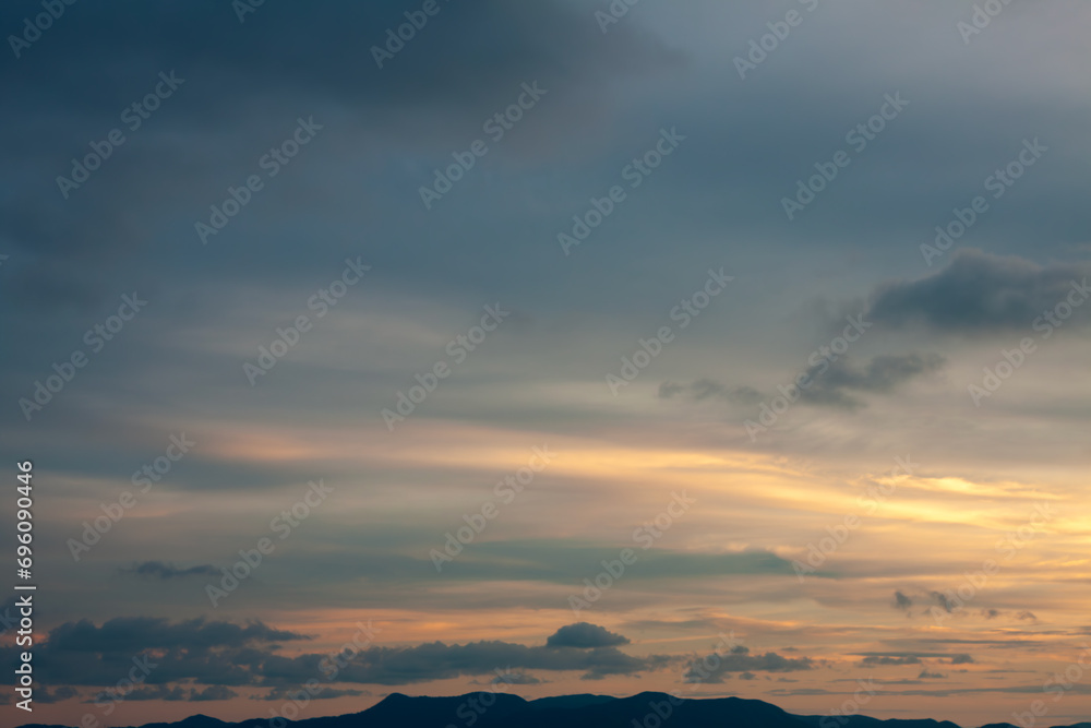 Cinematic romantic warm sky with sunset pastel clouds illuminated by last sun rays before sunset