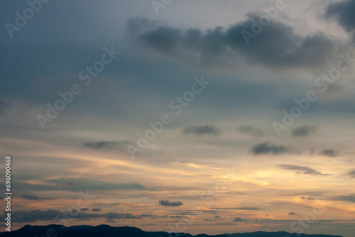 Cinematic romantic warm sky with sunset pastel clouds illuminated by last sun rays before sunset © ABContent Creator