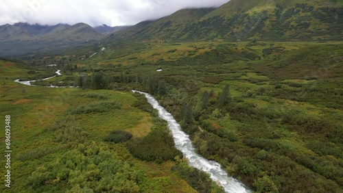 ALASKA - 2023 - Excellent aerial footage approaching and passing over a river in Alaska's Hatcher Pass, headed towards the mountains. photo