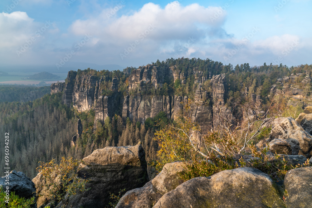 Panoramic bird's eye view of monumental sandstone pillars near the village of Kurort Rathen in the Saxon Switzerland national park near Dresden and the Elbe river, Saxony, Germany. Panoramic bird's eye view of monumental sandstone pillars near the village of Kurort Rathen in the Saxon Switzerland national park near Dresden and the Elbe river, Saxony, Germany.