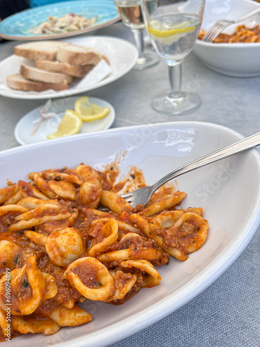 Orecchiette with tomato ragu. Traditional pasta in Puglia, Southern Italy.