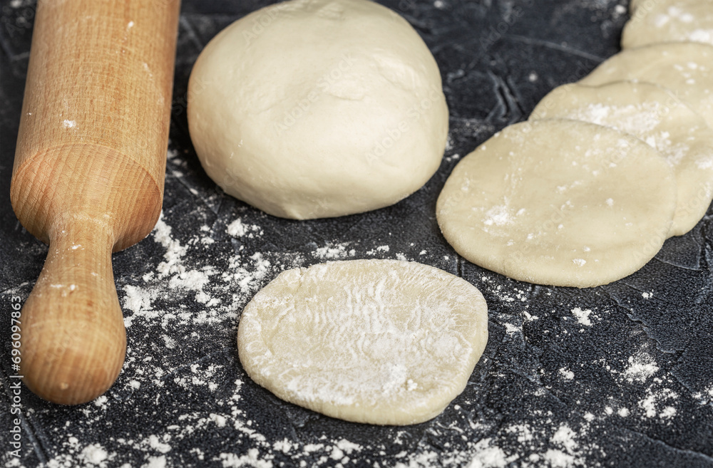 ball of fresh raw dough, flour and rolling pin top view ball of fresh raw dough, flour and rolling pin top view