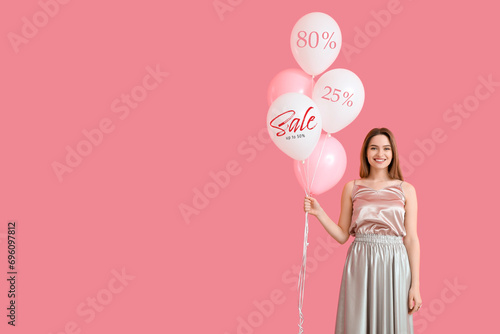 Pretty young woman with balloons on pink background. Concept of sale