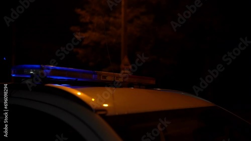 Police car with emergency lights in action.. The police arrived at the scene of the crime. The police blocked the road with a service car.