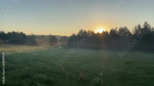 sunrise over morning fog sun shining beams through the air outdoors nature inspirational country side woods lanscape