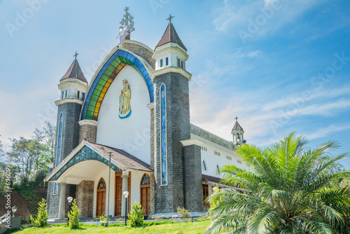 Velankanni Matha catholic church facade with palms in foreground, Nedumkandom, Kerala, South India photo