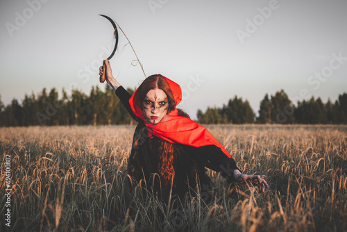 Witch with sickle photo