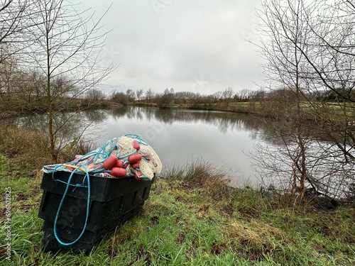 Fishing equipment floats and nets by a lake in the English countryside