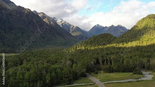 Aerial landscape flying in Eglington valley of New Zealand along river as 4k.
 photo