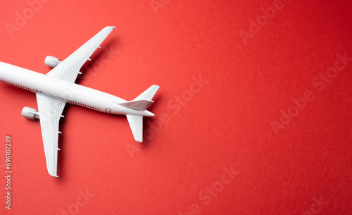 White passenger airplane on a red background. Booking flight tickets. Planning your trips. Additional service at airports. Arrival and departure. Business and tourism. Airline.